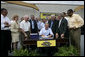 President George W. Bush signs the Transportation Equity Act, at the Caterpillar facility in Montgomery, Ill., Wednesday, Aug. 10, 2005. Joining the President on stage in front row, from left, are Congressman Ray LaHood, R-Ill.; Congresswoman Melissa L. Bean, D-Ill.; Congressman Jim Oberstar, D-Minn.; Congressman Tom Petri, R-Wis.; Senator Kit Bond, R-Mo.; U.S. Transportation Secretary Norman Mineta; Speaker of the House Dennis Hastert, R-Ill.; Congressman Bill Thomas, R-Calif.; and Congressman Bobby Rush, D-Ill. White House photo by Eric Draper